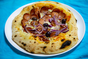 Rustic artisanal pepperoni pizza with red onion