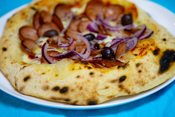 Rustic artisanal pepperoni pizza with red onion