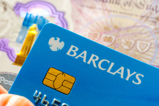 Barclays debit card close-up with British currency background. Highlighting digital banking services, secure payments, and financial solutions. Stafford, United Kingdom, October 6, 2024.