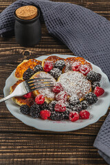 Cottage cheese pancakes with fresh raspberries, blackberries and powdered sugar
