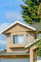 A perfect neighborhood. Houses in suburb at Fall in the north America. Top of a luxury house with nice window over blue sky.