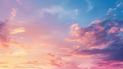 Obraz premium Soft pink clouds in a pastel sunset sky. Tranquil evening sky concept for design and print.