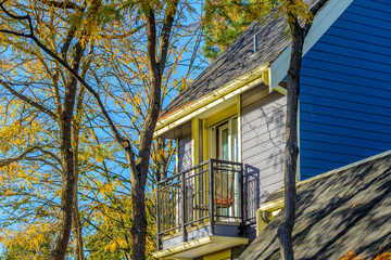 A perfect neighborhood. Houses in suburb at Fall in the north America. Top of a luxury house with...