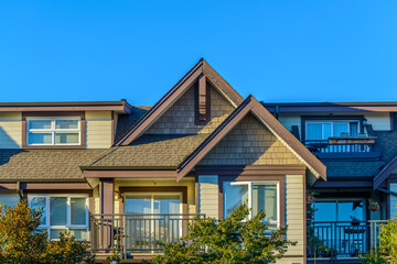 A perfect neighborhood. Houses in suburb at Fall in the north America. Top of a luxury house with...