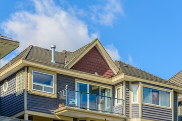 A perfect neighborhood. Houses in suburb at Fall in the north America. Top of a luxury house with nice window over blue sky.