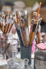 Close-up of a used set of paintbrushes in a studio.