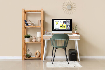 Interior of web designer's office with workplace and shelf unit