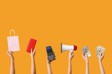 Hands with payment terminal, megaphone, money and shopping bag on yellow background. Black Friday sale