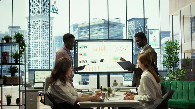 In a multinational company, advisory board meeting to discuss global strategies and work on finance planning. Managers ensuring the integration of development to drive profitability. Camera B.