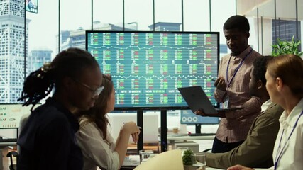 Diverse work team meeting in the boardroom to discuss corporate briefing reports and sharing innovative ideas. Employees plan effective marketing strategy for the upcoming quarter. Camera B.