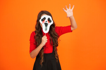 Happy Halloween. Girl ghost on Halloween party isolated on orange. Trick or treat. All Hallows party celebration. All Hallows ghost. Spooky party mask. Girl with Halloween ghost mask. Day of dead