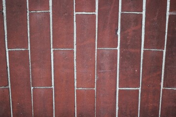 A red brick wall with white mortar.