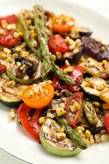 Delicious salad with grilled vegetables on plate, closeup