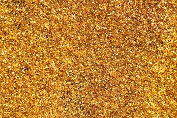 Beautiful shiny golden glitter as background, top view