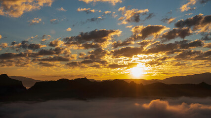 Sunset mountain range beautiful landscape mist foggy sunrise beam. Golden sky Mountain landscape foggy windy mountain. Amazing Landscape cloud sky on sunrise. Countryside gold sunlight heaven scene