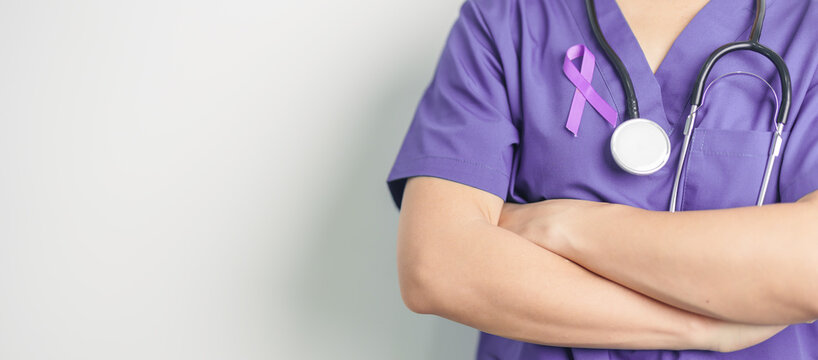 Doctor holding purple Ribbon for Violence, Pancreatic, Esophageal, Testicular cancer, Alzheimer, epilepsy, lupus, Sarcoidosis and Fibromyalgia. Awareness month and World cancer day concept