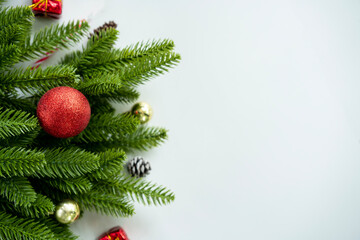 Christmas tree branch with decorations on white tabletop background