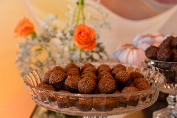 chocolate on a plate, chocolate ball, chocolate,brigadeiro, candy table, glass bowl, brazilian sweets, brigadeiro on a plate, candy store, showcase
