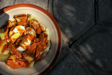 a portion of delicious dumplings covered in peanut sauce is ready to eat