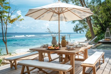 Coastal Dining Table Set with Umbrella on Beach House Deck Overlooking the Ocean