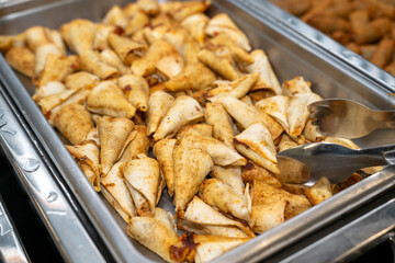 Grilled chicken and cheese quesadilla appetizer in a metal serving tray at a party