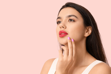 Beautiful young woman with stylish makeup on pink background