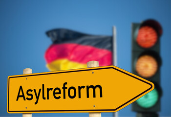 Flagge von Deutschland, eine Ampel und Diskussion über die Asylreform