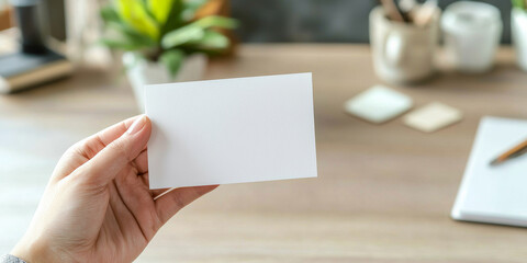 Obraz premium Close up of a hand holding a blank business card mockup, generative AI
