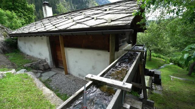 Traditional Watermill At The Mountain Village Blatten Bei Naters In Switzerland. Static Shot