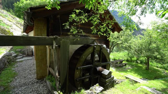 Traditional Water Wheel At The Mountain Village Near Blatten Bei Naters In Switzerland. Static Shot