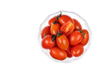 The dessert bowl is filled with fresh cherry tomatoes. white background - Solanum lycopersicum var....