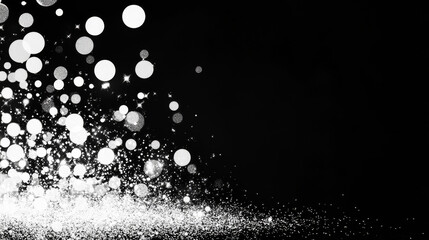 Sparkling silver glitter on a black background.