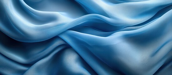 Obraz premium Abstract background of blue silk fabric.
