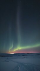 A cold, clear polar night sky with the faint glow of the sun on the horizon and a sky full of stars and aurora lights shimmering
