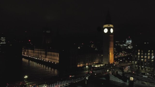 Aerial drone fast moving arc video of Big Ben and Houses of Parliament at night (After renovation)