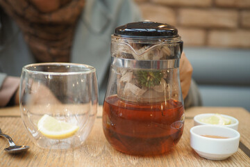 Enjoy a cozy tea experience featuring a delightful French press and an array of fresh, tasty fruits