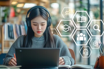 Young Asian Woman Engaged in E-Learning with Laptop and Headphones in Modern Library Setting with Digital Icons Overlay