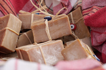 Discover beautiful handmade organic soap bars presented in a wicker basket with colorful fabrics