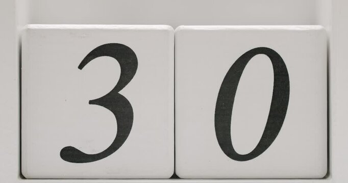 Close-up of white calendar blocks displaying the number 30 in black font. Ideal for date representation, scheduling, and reminder concepts. White Calendar Blocks Showing Number 30 in Black Font