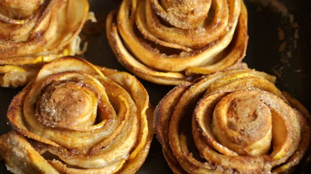 Baked puff pastry Apple Roses on a baking sheet tray. Close up.