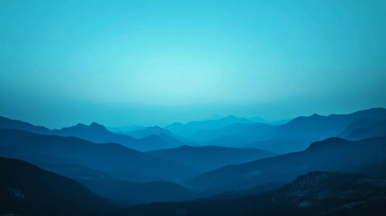 Obraz premium A serene landscape featuring a deep blue sky contrasted against black mountain silhouettes, set against a smooth blue and white gradient background.