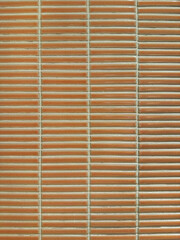 Horizontal orange and clay subway tiles with white grouts. Seamless tiles background texture.