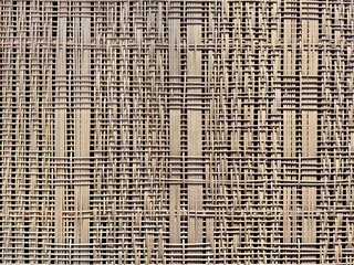 Close up photo of beautiful hand woven synthetic rattan texture in natural light brown color....