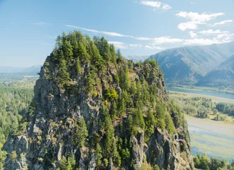 Fototapeten Sommer A mountain with a forest on top and a river below  © Anton