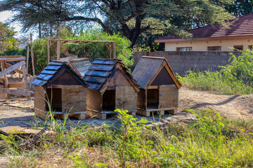 wood dog houses on the side of the road, african street vendor small business