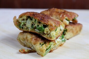 Egg Martabak or Egg Martabak. Savory fried pastries filled with eggs, meat and spices. Martabak Telur is one of the street snacks in Indonesia.