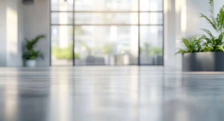 Blurred background of a modern office interior featuring glass windows and a polished floor, with a focus on the hallway