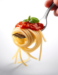 Spaghetti on a fork with tomato sauce and basil leaf on a white background