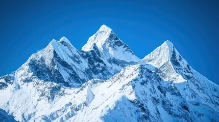 fresh snow on mountain peaks under a clear blue sky, symbolizing serenity and adventure.