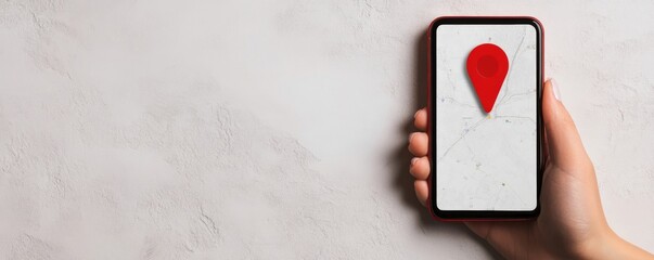 Hand holding smartphone with red location pin on a white background.
